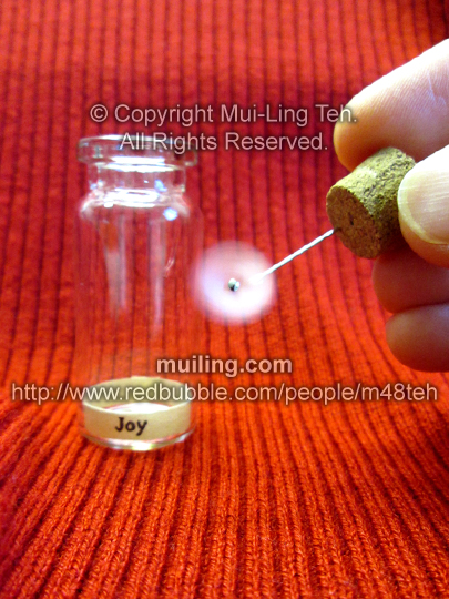 spinning origami cherry blossom pinwheel in a bottle by Mui-Ling Teh