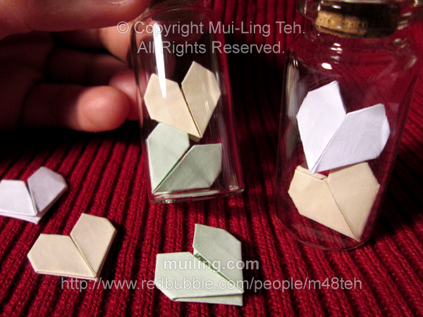 Two stacked origami hearts in bottles by Mui-Ling Teh
